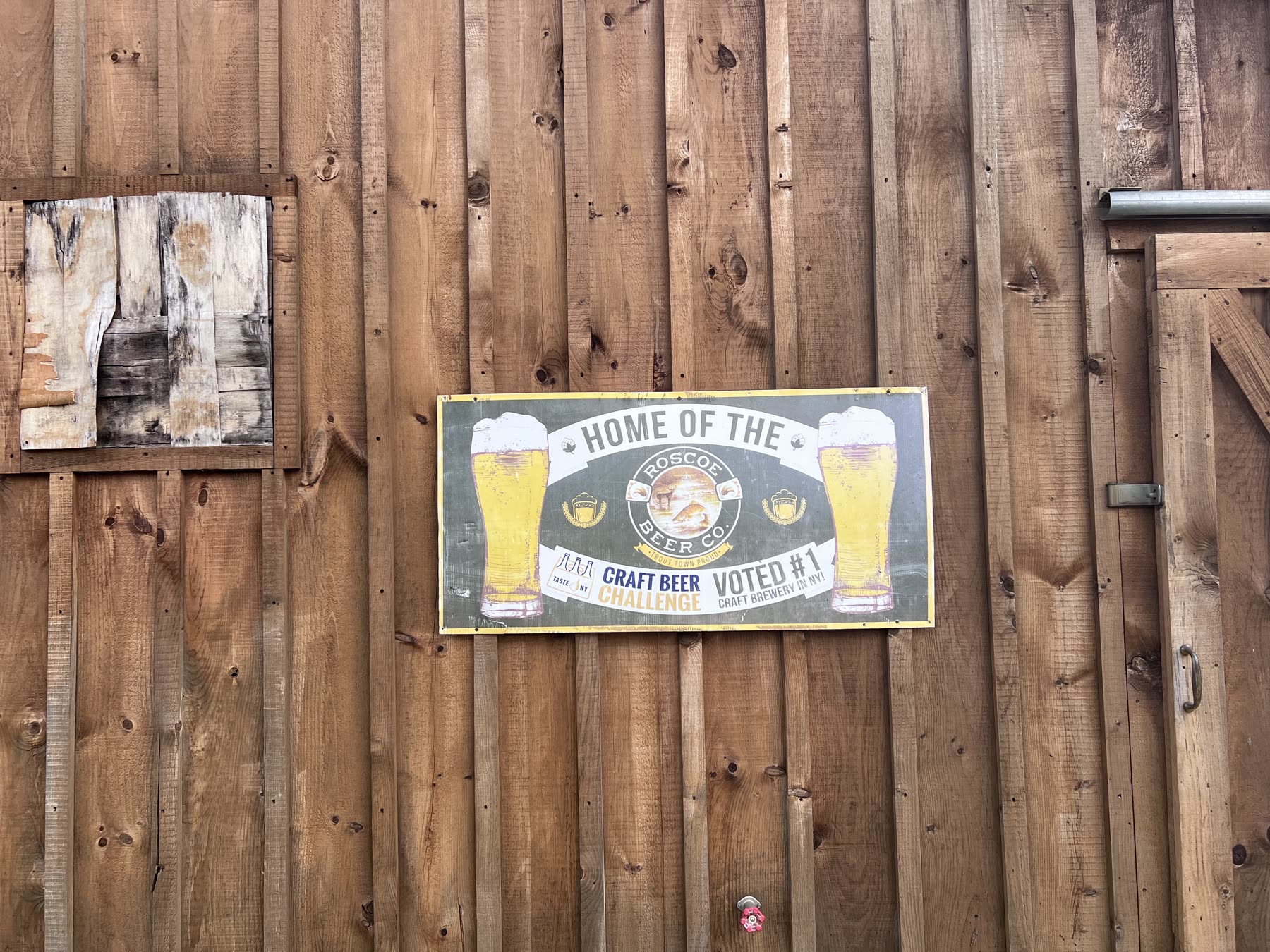 Roscoe Beer Company craft beer sign mounted on a rustic wooden wall in Roscoe, New York